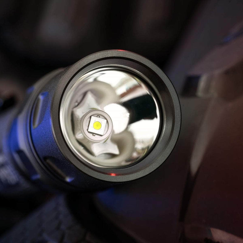 Close-up view of the lens and LED bulb inside a black Weltool T15 LED tactical flashlight, highlighting the reflective interior surface.