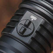 Close-up of a black ridged rotary switch with two raised tabs and a white power symbol, as seen on waterproof USB-C charging devices like the Weltool W5R Pro LEP rechargeable flashlight.