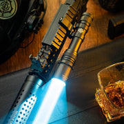 The Weltool W65S tactical LEP weapon light, mounted on a firearm, projects a powerful beam; nearby on a dark surface sit a glass of amber liquid and a helmet.