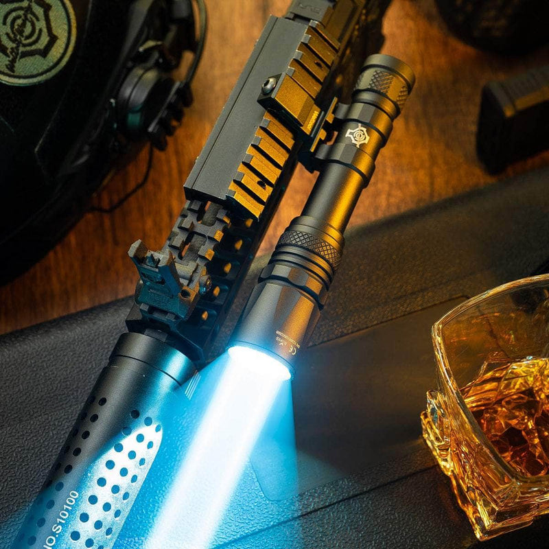 The Weltool W65S tactical LEP weapon light, mounted on a firearm, projects a powerful beam; nearby on a dark surface sit a glass of amber liquid and a helmet.