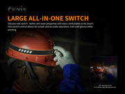 The worker, equipped with a helmet, adjusts the sizeable all-in-one switch on a multi-functional headlamp featuring a 180° adjustable beam. The visible safety gear and gloves emphasize the effectiveness of the Fenix HM61R, showcasing its dual light sources.