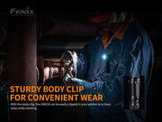 While working on machinery, a person highlights the convenience of the Fenix HM61R by attaching it to their chest with a body clip and utilizing its dual light sources.