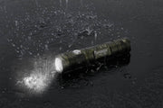 A Manker MC11 II in the rain on a black background.