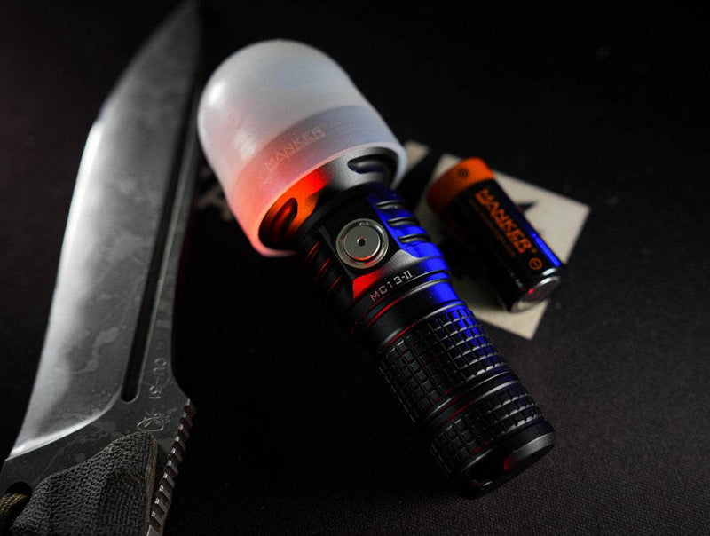 A Manker MC13 II with a flashlight next to it.