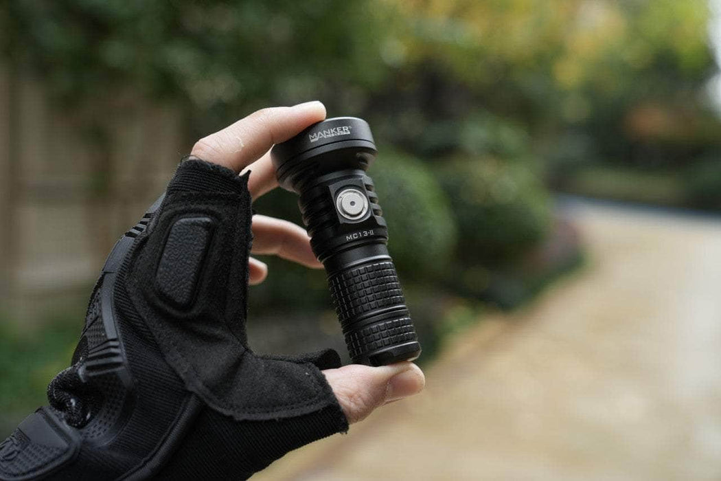 A person holding a Manker MC13 II in their hand.