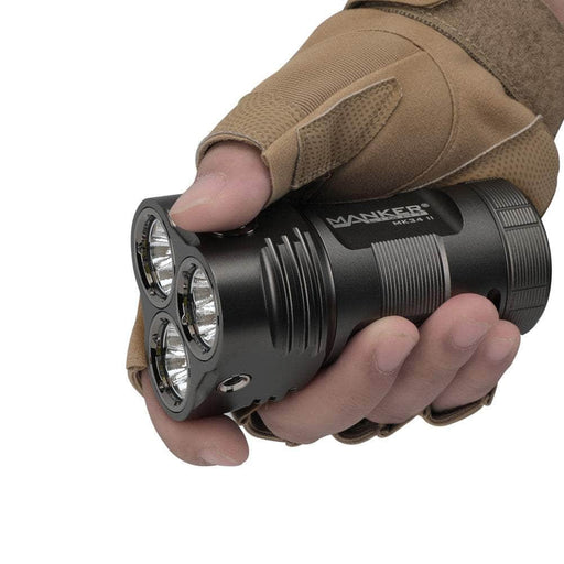 A person holding a Manker MK34 II flashlight in their hand.