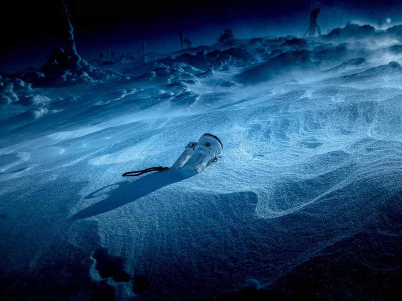 An image of a Manker MK38 Satellite (Powered by 3x 21700 Batteries) in the snow.