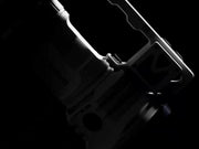 A black and white image of a Manker MK38 Satellite (Powered by 3x 21700 Batteries) in the dark.