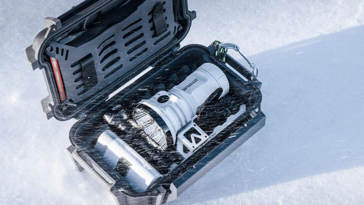 A Manker MK38 Satellite (Power by 3x 21700 Batteries) with a tool in it sitting in the snow.