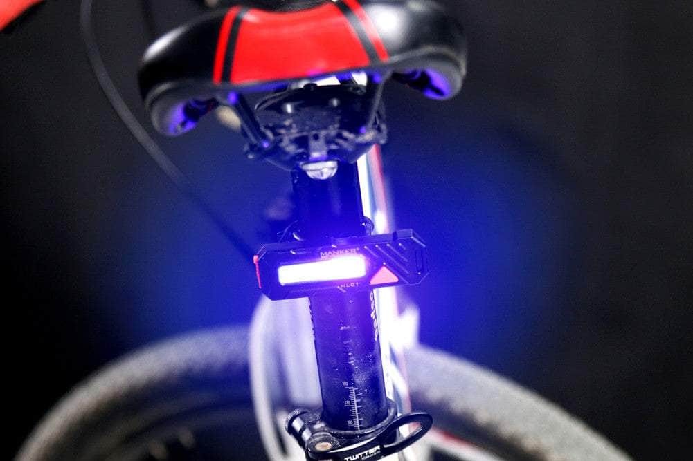 A close up of a Manker ML01 with a purple light on the handlebars.