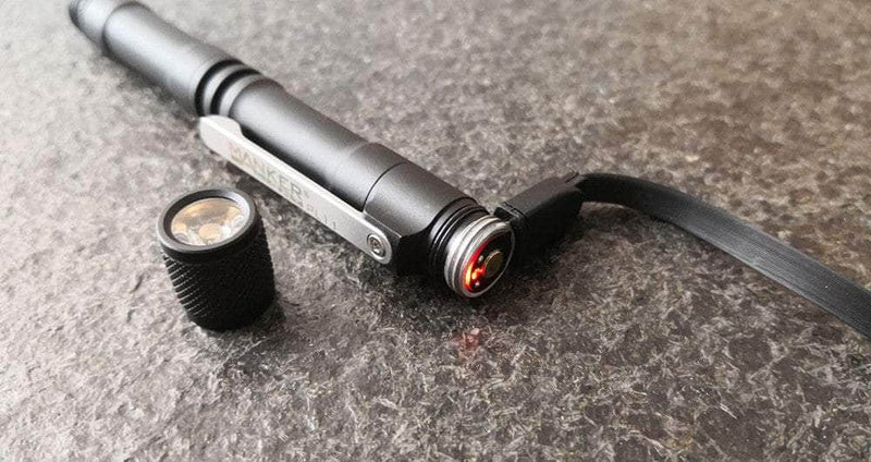 A Manker PL11 with a red light on top of it.