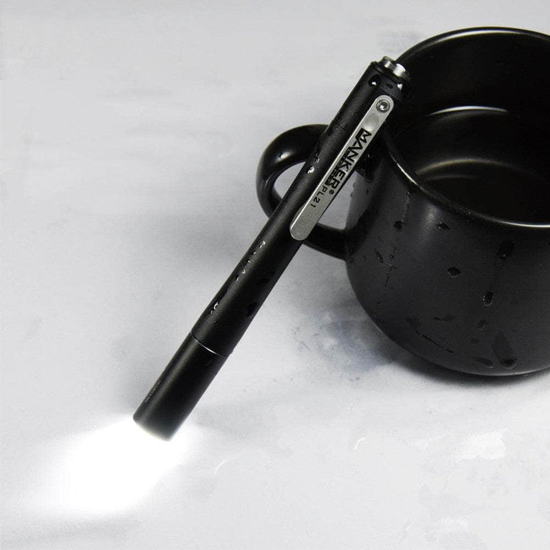 A Manker PL21 is sitting on top of a cup of coffee.