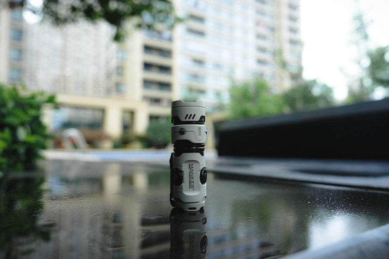 The Manker Timeback III sits on top of a glass table.