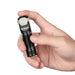 A hand holding a Manker E03H II flashlight.
