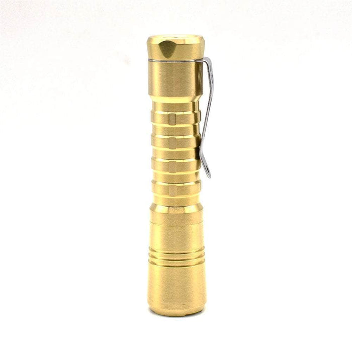 A ReyLight Pineapple Brass flashlight on a white background.
