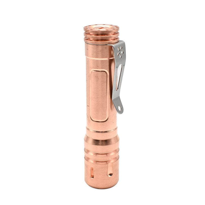 A ReyLight Pineapple Copper flashlight with a metal handle on a white background.