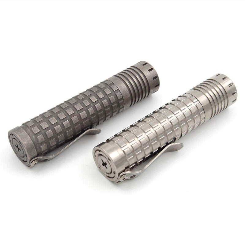 Two ReyLight Ti Dawn Triple metal flashlight bodies with textured grips and belt clips are side by side on a plain background. One has a square pattern, while the other shines with Nichia 519A emitters and a sapphire lens for exceptional clarity.