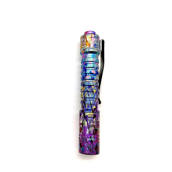 A ReyLight Pineapple Mini Titanium Anodized flashlight with a colorful design on it.